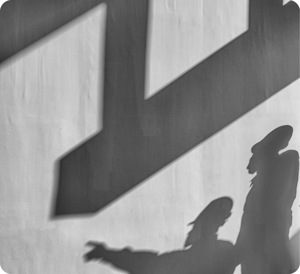 Shadows of two figures on wall